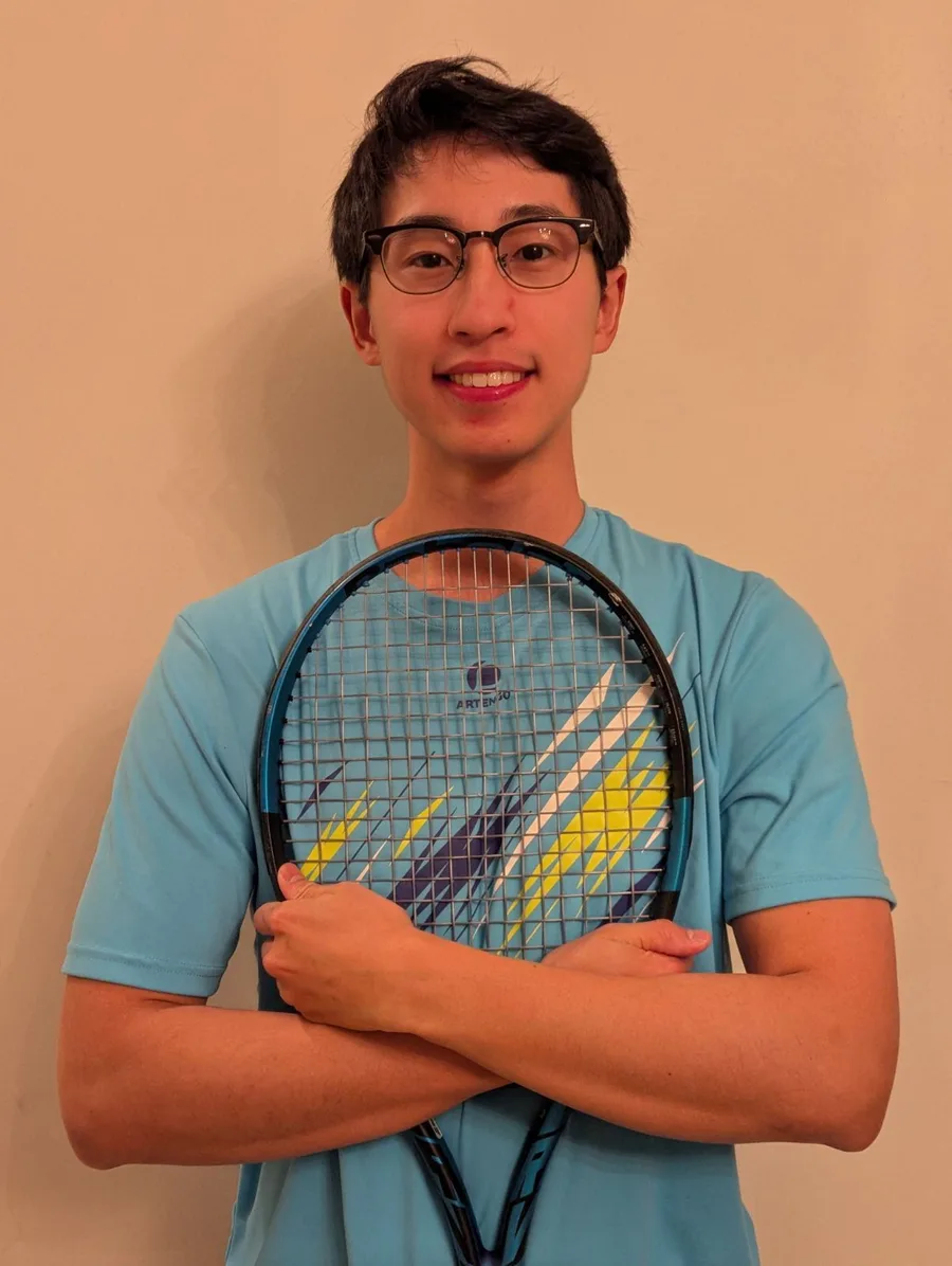 Bovie Liu, tennis coach at Brainiac Tennis, holding a racket